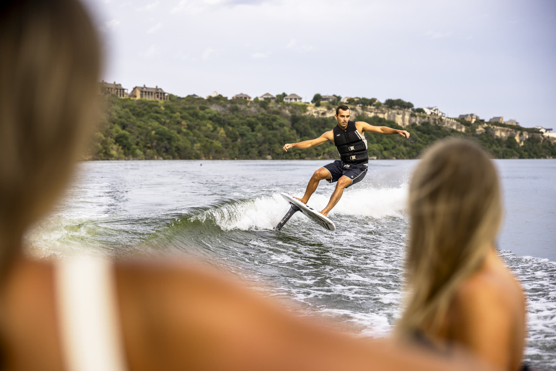 Rider carving the wave on a foil board during a coached session at Lake of the Ozarks