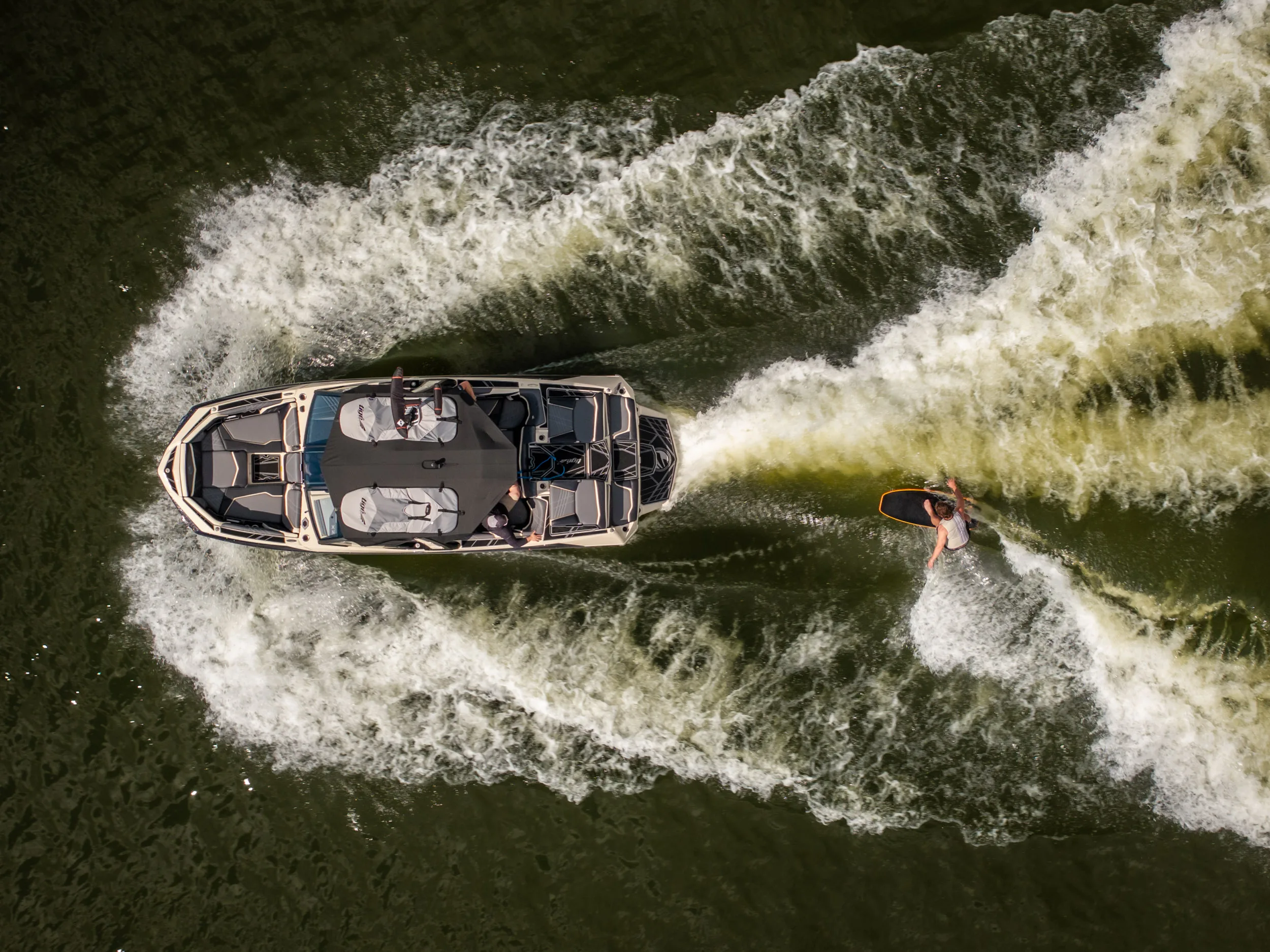 Aerial view of wake surfing behind Tige boat