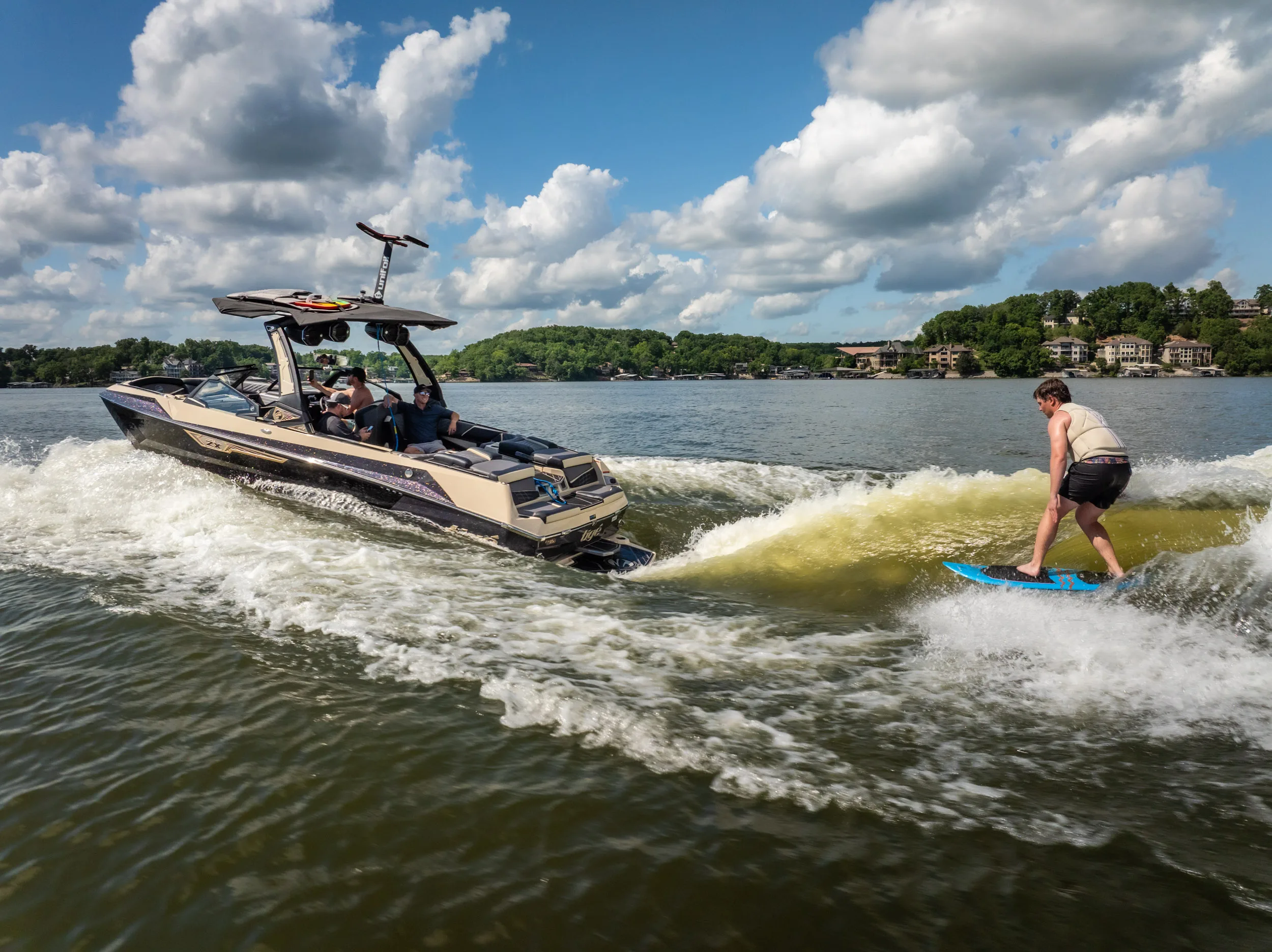Wake surfing action shot behind Tige boat